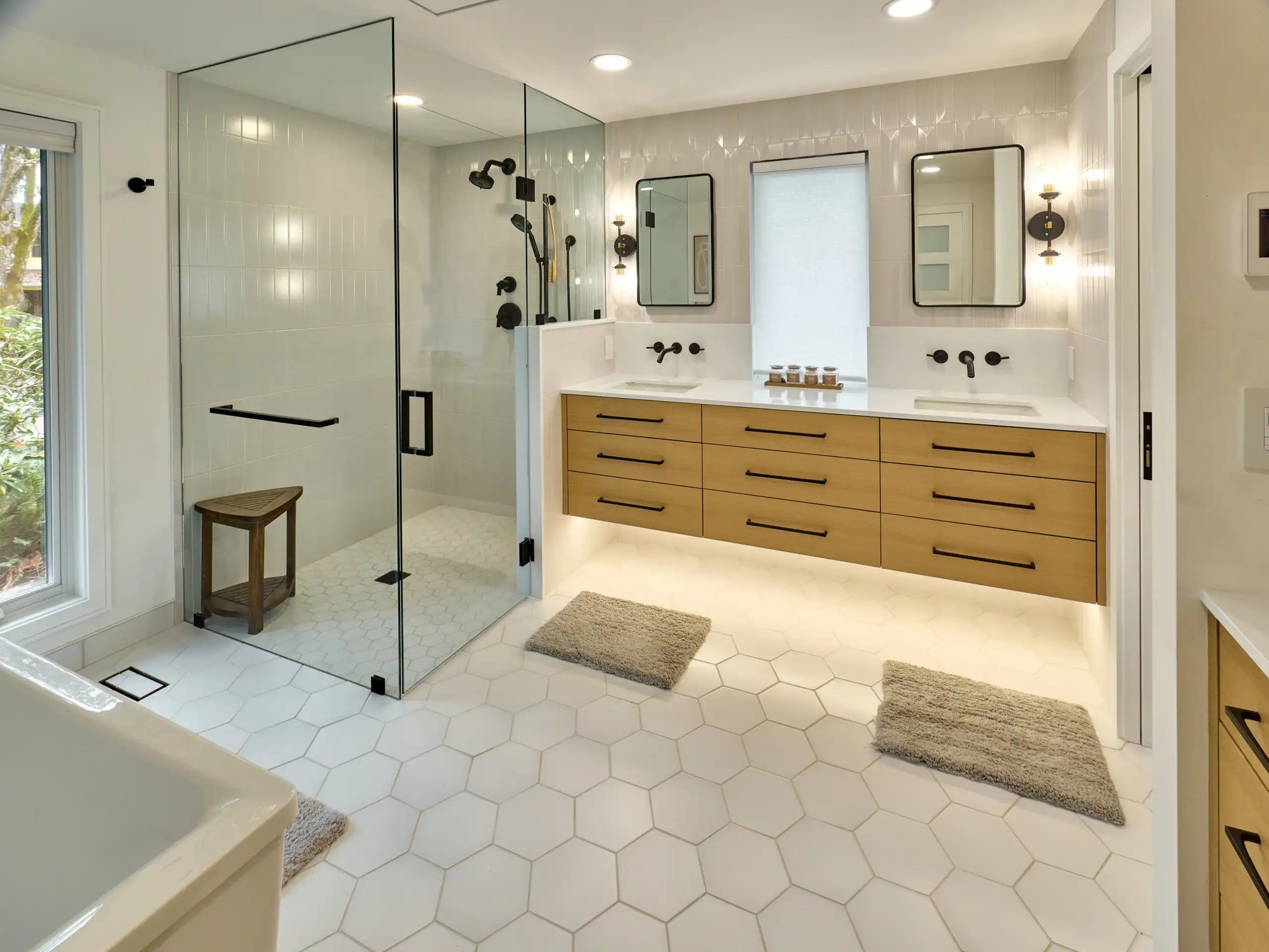 Spacious bathroom with glass shower, floating vanity, and hexagonal tile floor | modern shower ideas | Ace Decor