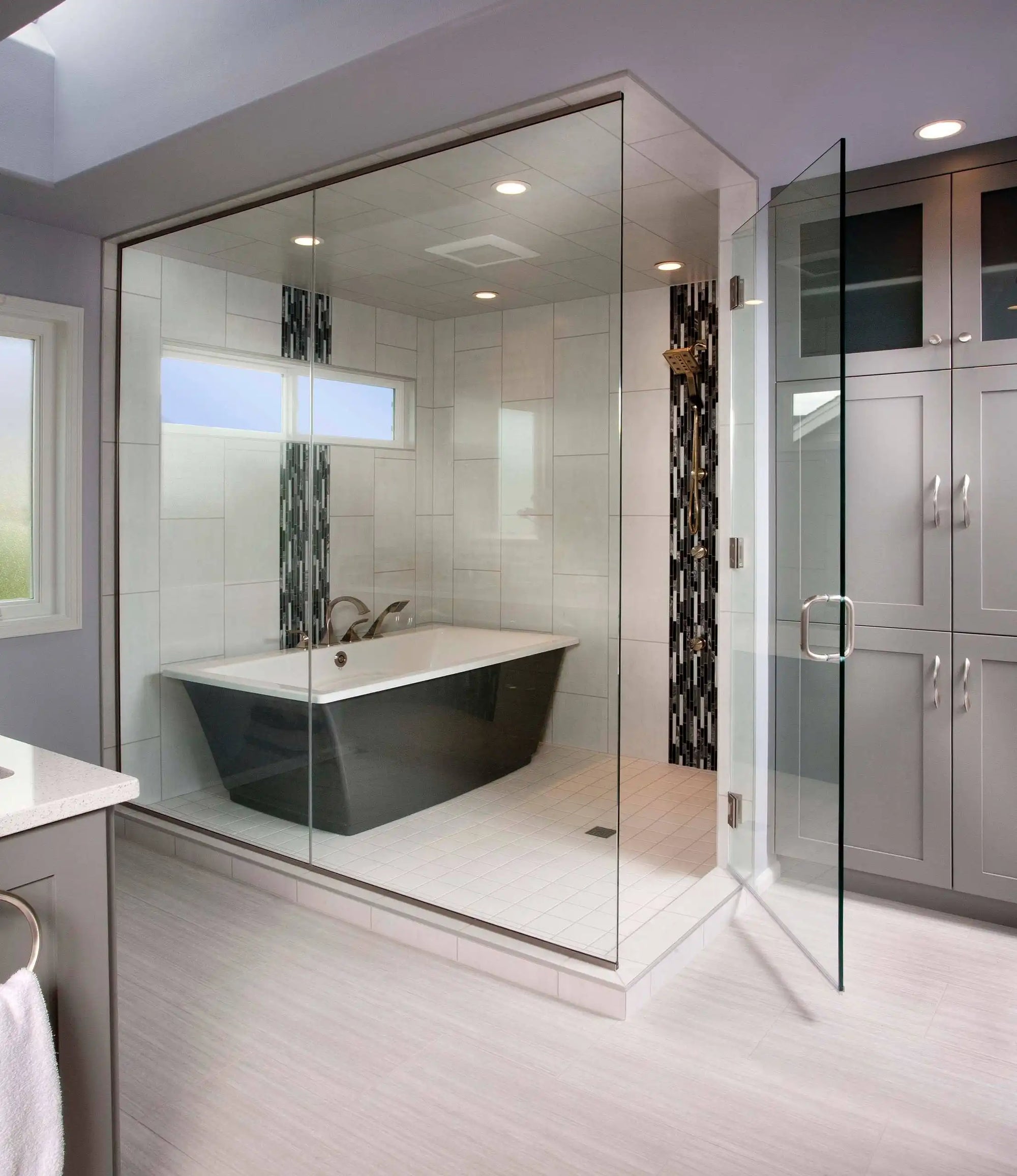 This image features a sleek freestanding bathtub shower enclosed with glass walls, showcasing a modern bathroom design. | ACE DECOR