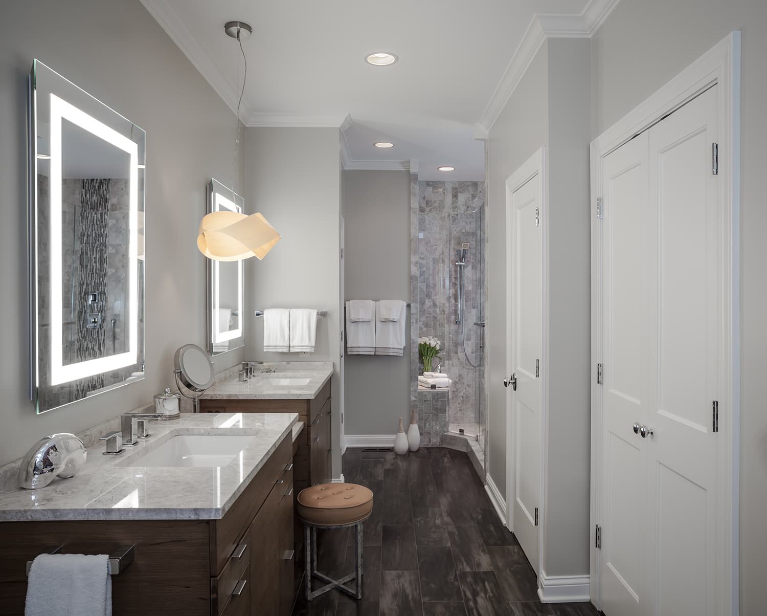 A luxurious bathroom with dual vanities and striking rectangular LED lights for bathroom mirror use, casting a clean, modern glow over elegant marble countertops. | ACE DECOR