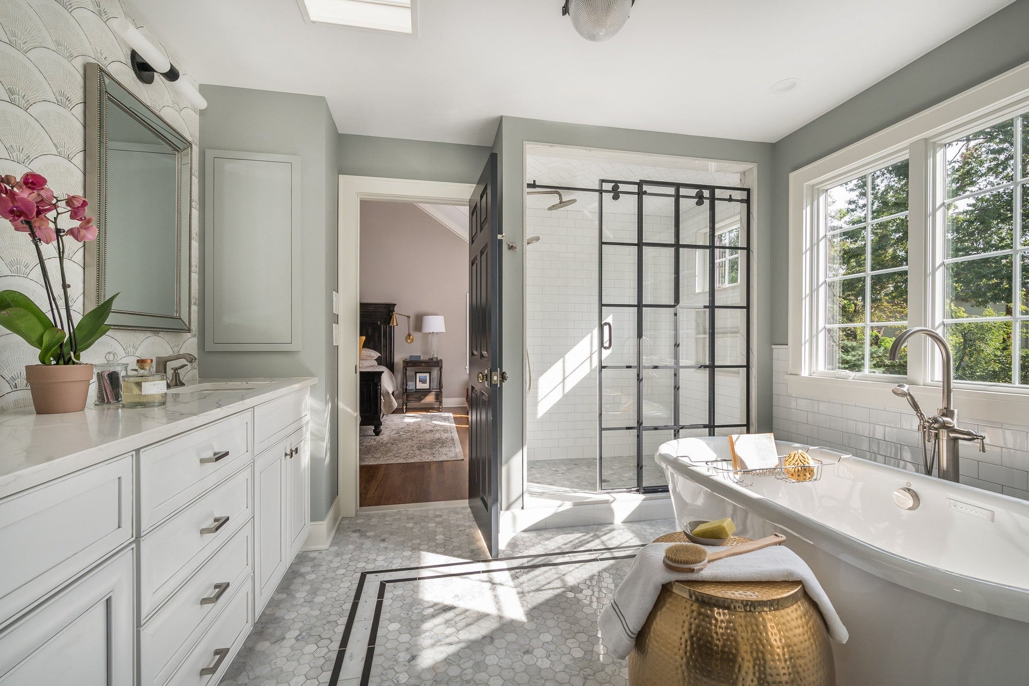 A bright, elegant bathroom featuring black-framed sliding shower doors and a soaking tub — proof that style doesn't mean sliding shower doors leak | ACE DECOR