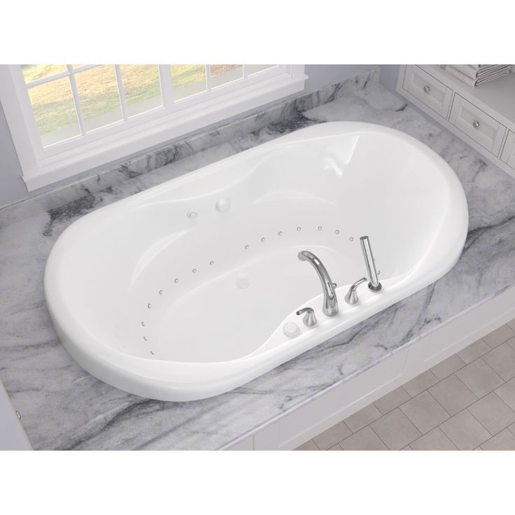 Oval drop-in jetted bathtub on marble base, commonly seen in jetted bathtub repair scenarios