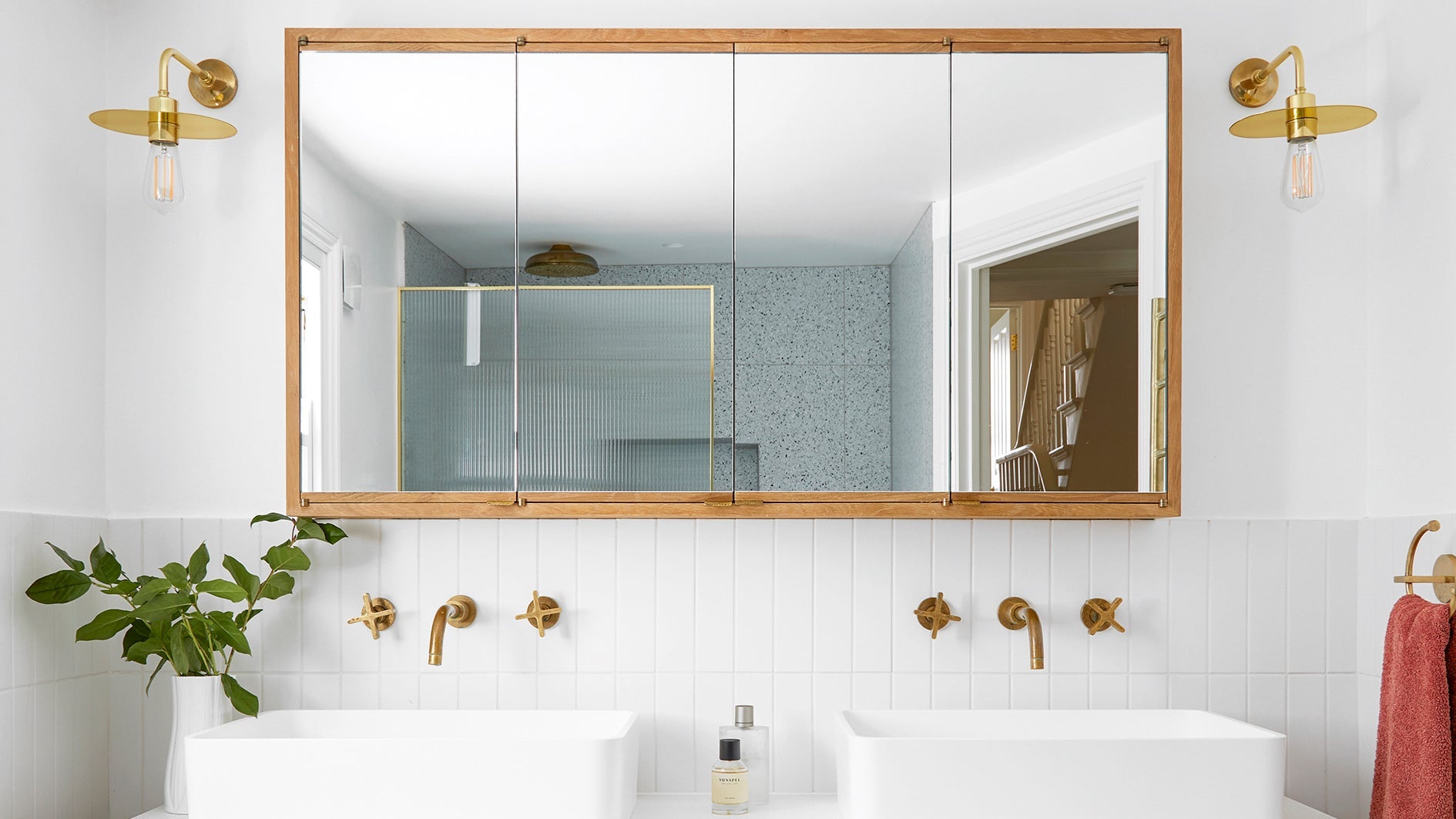 Wood-framed decorative mirrors for bathroom with gold fixtures in a double sink setup