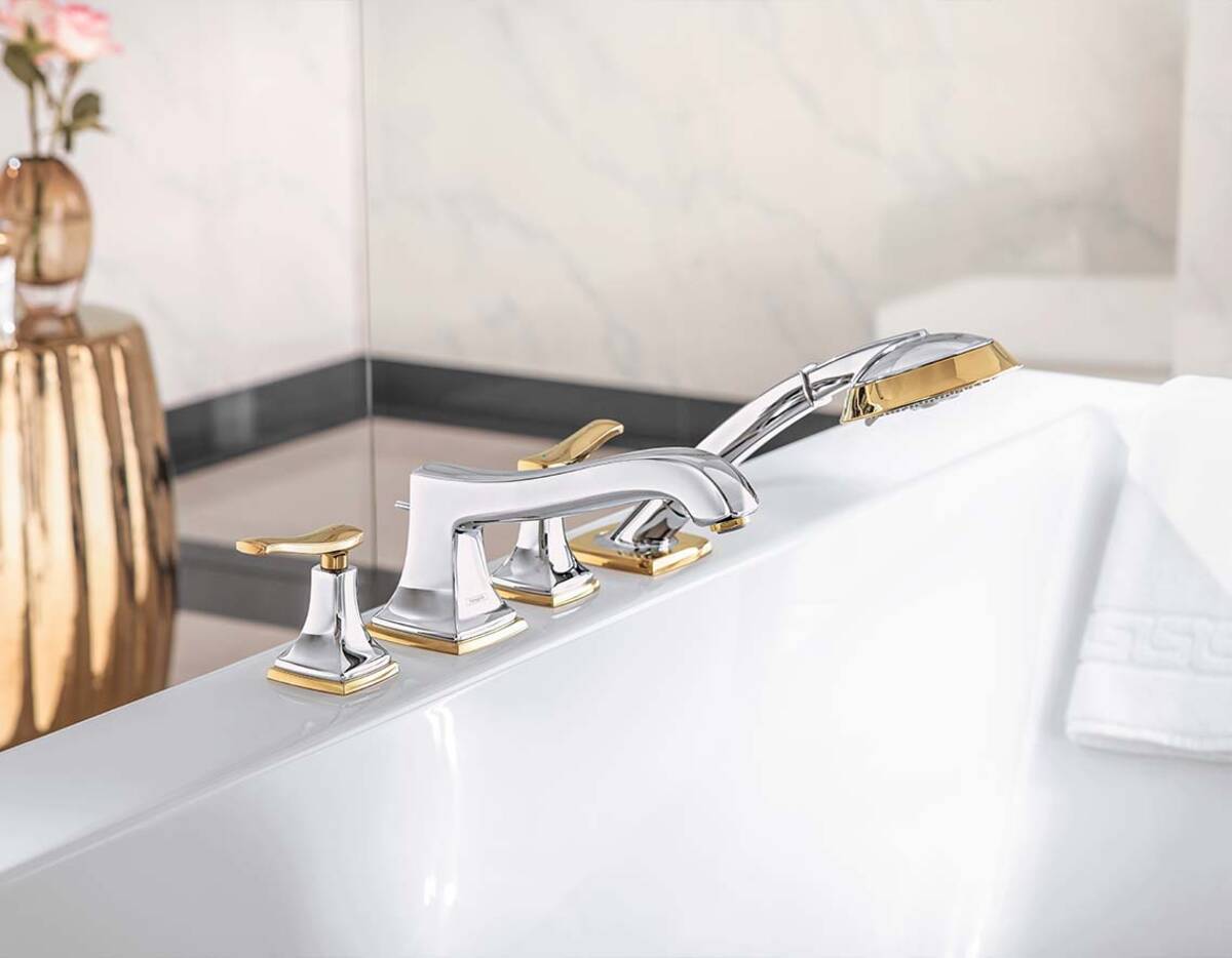 Luxury bathtub faucet with gold and chrome finish, dual handle temperature control and handheld shower.