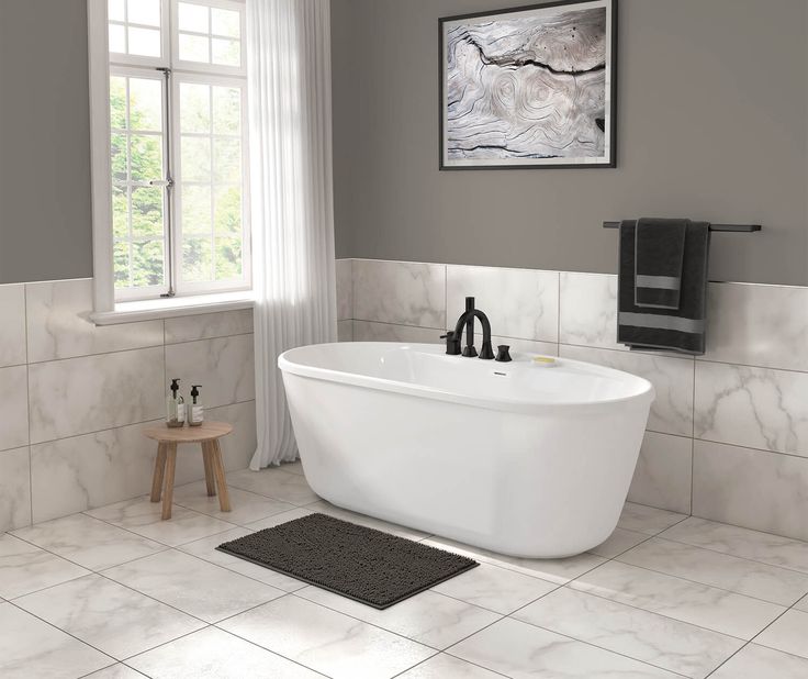 Sleek freestanding soaking bathtub with champagne bronze wall-mounted faucet in a modern bathroom
