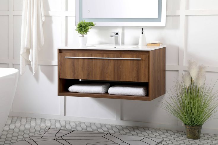 Modern walnut floating vanity for bathroom with open towel shelf and white top.