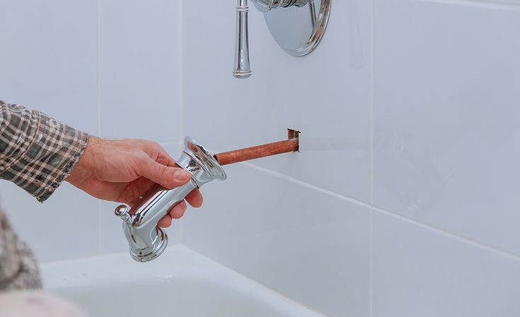 Replacing old bathtub faucets during bathroom plumbing upgrade