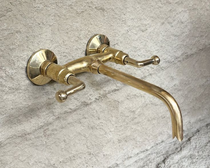 Unlacquered brass wall-mounted faucet with exposed bathtub faucet valve parts