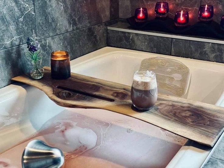 Walnut live edge bathtub trays with candles, flowers, and a coffee cup for a relaxing bath experience