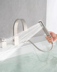 FLUNIX Brushed Nickel Waterfall Roman Tub Faucet Set with handheld shower in use.