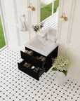 24" black single sink bathroom vanity with two open storage drawers in a bright modern bathroom.