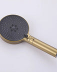 Front view of the brushed gold handheld shower head.