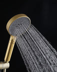 Brushed gold handheld shower head with a soft, relaxing rainfall spray.