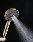 Brushed gold handheld shower head with a powerful, targeted spray.