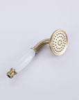 Brushed gold handheld shower head with white handle — classic design with even water spray.