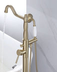 Back view of the brushed gold floor mount bathtub filler in use with running water flow.