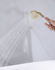 Brushed Gold Handheld Shower Head in Use — Strong Water Flow Demonstration for Freestanding Tub Faucet with White Handle.