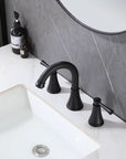 Top view of VALMIRA Matte Black Sink Faucet installed on marble vanity and gray wall backdrop.