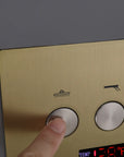 Hand pressing water mode selector button on a digital shower control panel