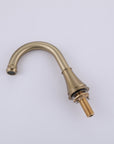 VALMIRA Brushed gold sink faucet with curved spout and threaded base.