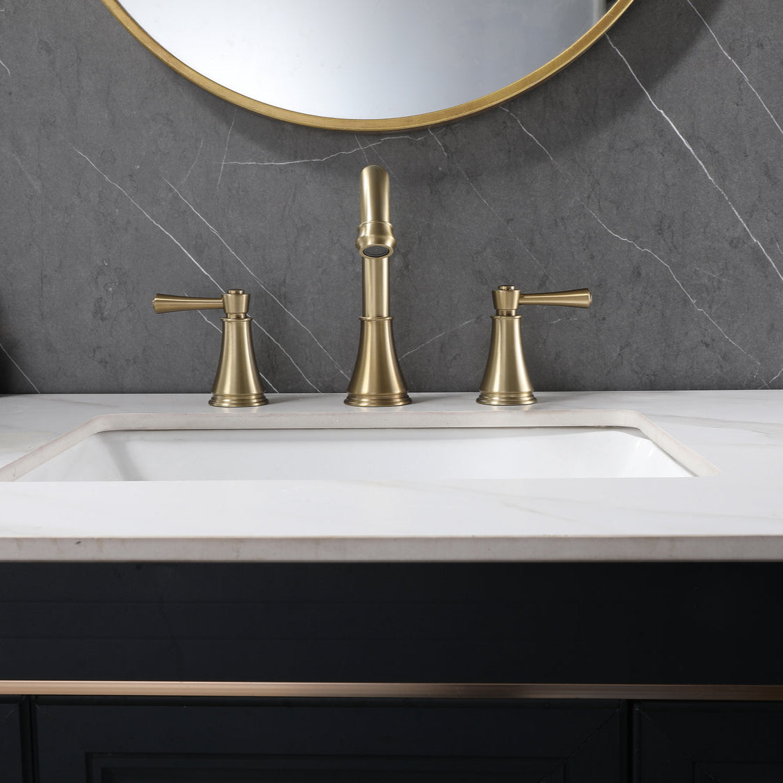 VALMIRA brushed gold sink faucet on white marble countertop.