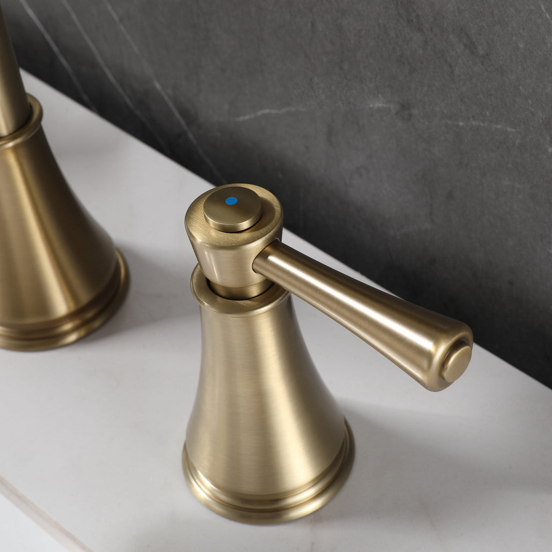 Close-up of VALMIRA brushed gold sink faucet.