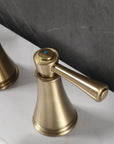 Close-up of VALMIRA brushed gold sink faucet.