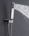 Brushed nickel handheld shower head spraying water with adjustable wall mount