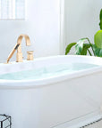 FLUNIX Brushed Gold Waterfall Roman Tub Faucet Set installed on freestanding bathtub.