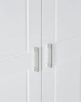 Close-up of sleek metal door handle on tall white bathroom storage cabinet.