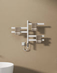 White heated towel rail radiator mounted on bathroom wall with brown towels neatly hung | Ace Decor