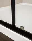 Close-up of Brivio Series matte black shower door bottom guide rail detail.