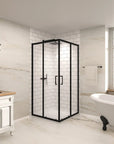Corner black framed double sliding glass shower enclosure in a modern bathroom setting with white tile walls and freestanding bathtub.