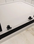 Quick release bottom rollers of the matte black corner shower enclosure.