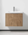 24 inch oka finish bloating bathroom vanity with sink chrome faucet installed in a modern bathroom.