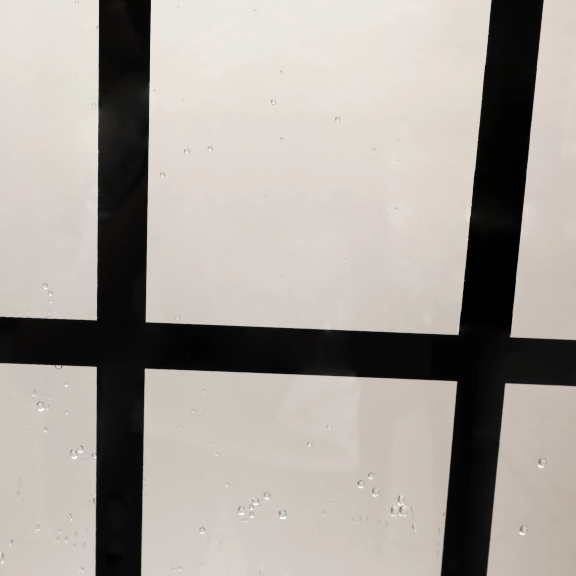 Close-up frame detail of grid glass shower door 38 x 72 inch black design | Ace Decor