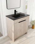 30 inch bathroom vanity with top displayed with black sink and faucet in bright bathroom setting | Ace Decor