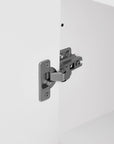 Close-up of the high quality metal hinge of the bathroom storage cabinet.