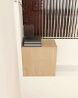 Side view of light wood 12 inch wall-mounted open storage cabinet on bathroom wall.