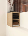 Light wood 12 inch wall-mounted open storage cabinet with shelves installed on bathroom wall, front view.
