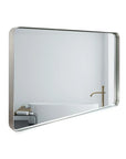 Lunare brushed silver rounded rectangle bathroom mirror shown from a side angle with aluminum frame and beveled edge.