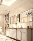 Lunare Series framed mirror in a luxury decorated bathroom, reflecting a crystal chandelier and floral wall art above a dual vanity with marble countertop.