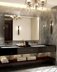Silvara Series Silver Framed Rectangular Bathroom Mirror installed on textured grey marble in a luxurious bathroom with gold crystal chandelier, sconces, and double vanity.