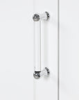 Silver door handle on White Valmor 68.1 inch tall Bathroom Storage Cabinet.