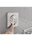 Adjustable brushed nickel body jet spray for targeted shower massage.