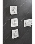 Cascade white wall-mounted installation of three square body jets in a modern bathroom.