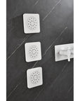 Cascade white wall-mounted installation of three square body jets in a modern bathroom.
