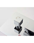Close-up of chrome shower diverter knob for switching between hand shower and rainfall shower