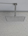 Overhead view of the Lorton brushed nickel 12" rain shower head installed in a bathroom, showing its wide rainfall coverage.