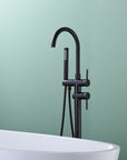 "Freestanding Black Tub Faucet with Handheld Shower installed beside bathtub, modern matte black finish for contemporary bathrooms.