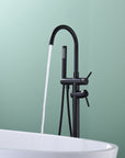 Freestanding Black Tub Faucet with Handheld Shower in use, water flowing into bathtub.